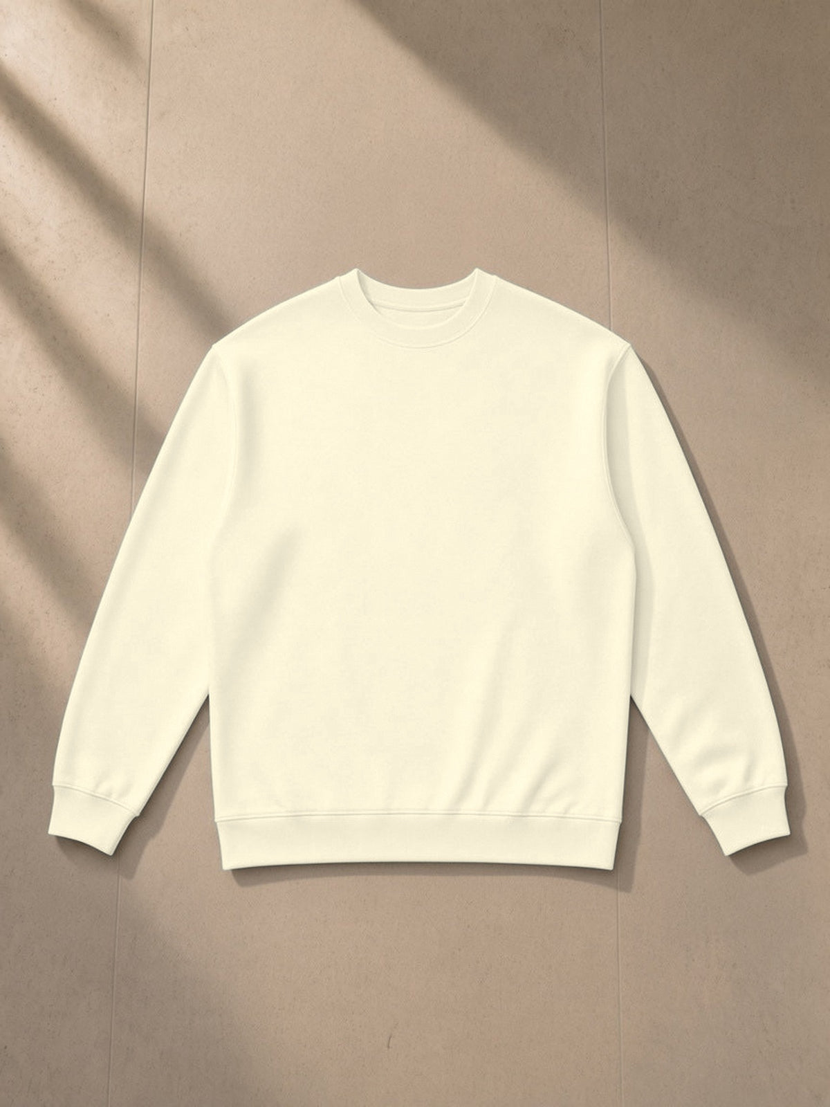 Oversized Crewneck Sweatshirt in Apricot, laid flat on pale limestone, front view