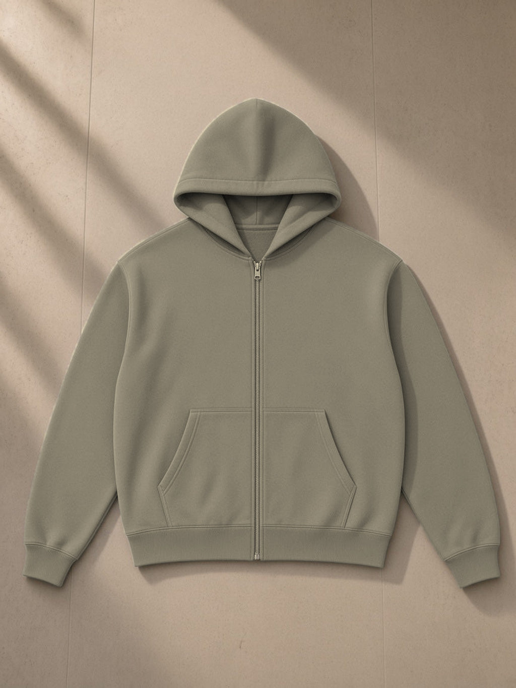 Essential fleece zip-through hoodie in Gray Coffee, laid flat on pale limestone, front view