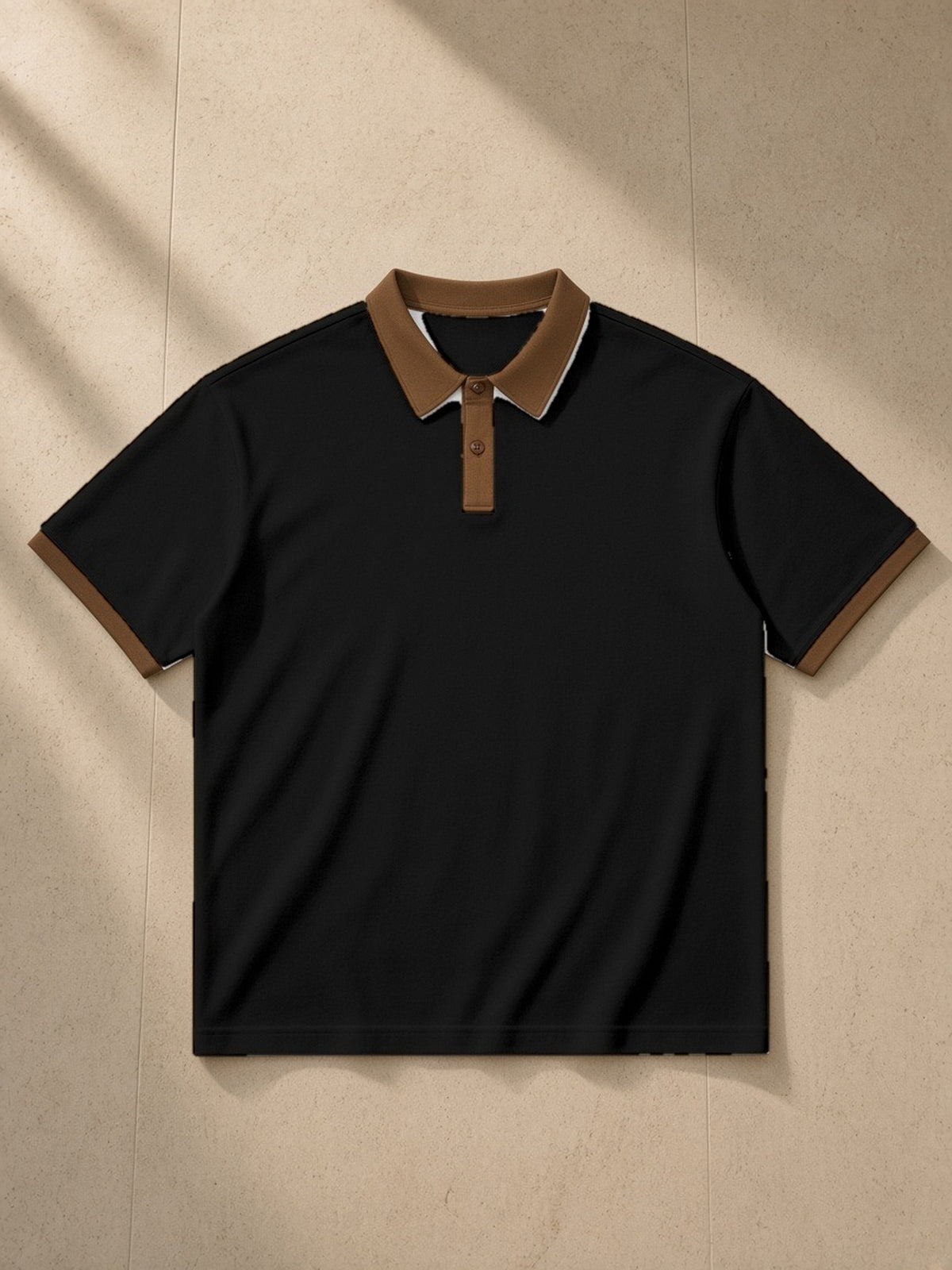 Color Block Polo Shirt in Black with Brown, laid flat on pale limestone, front view