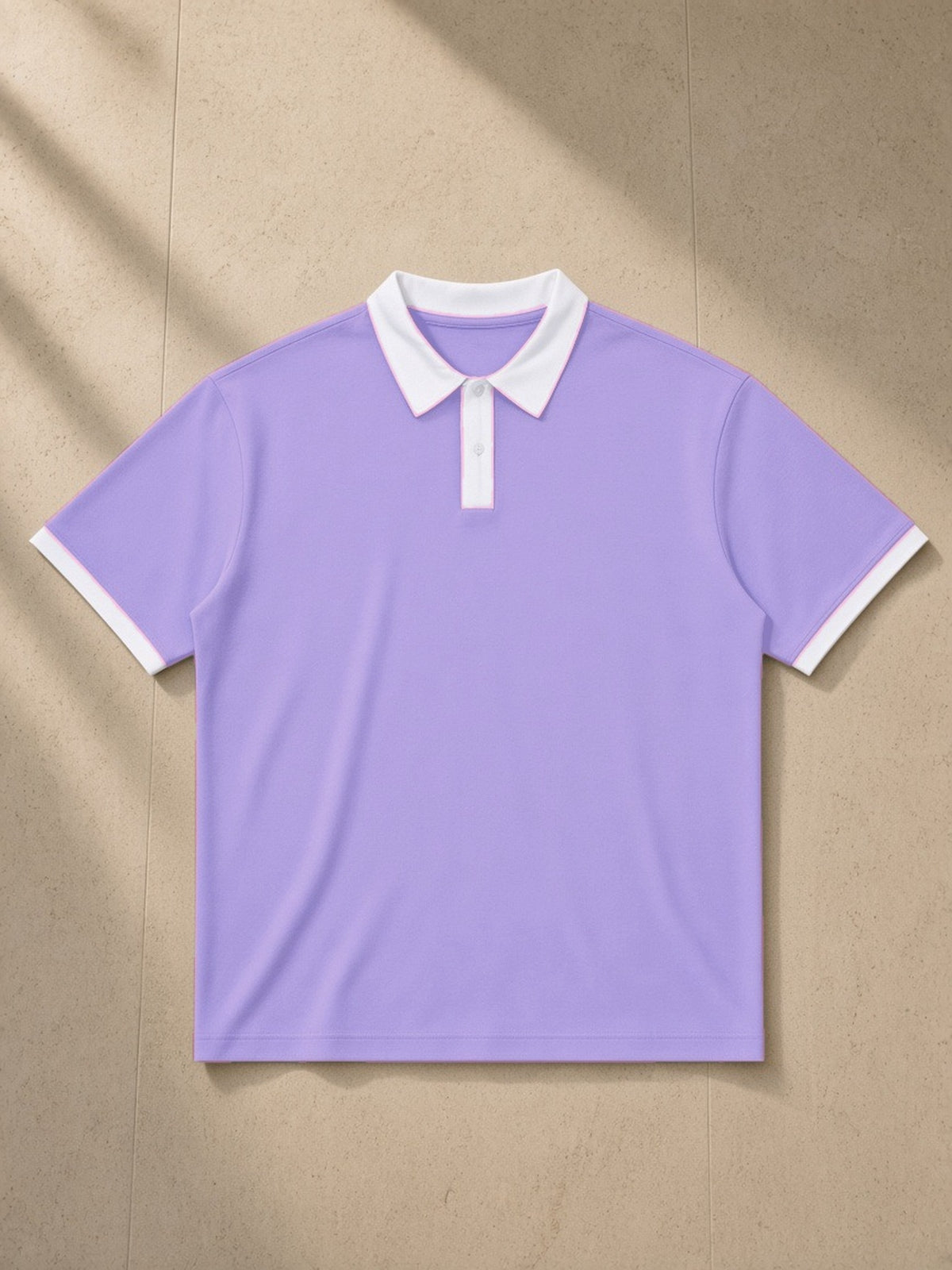 Color Block Polo Shirt in Light Purple with White, laid flat on pale limestone, front view