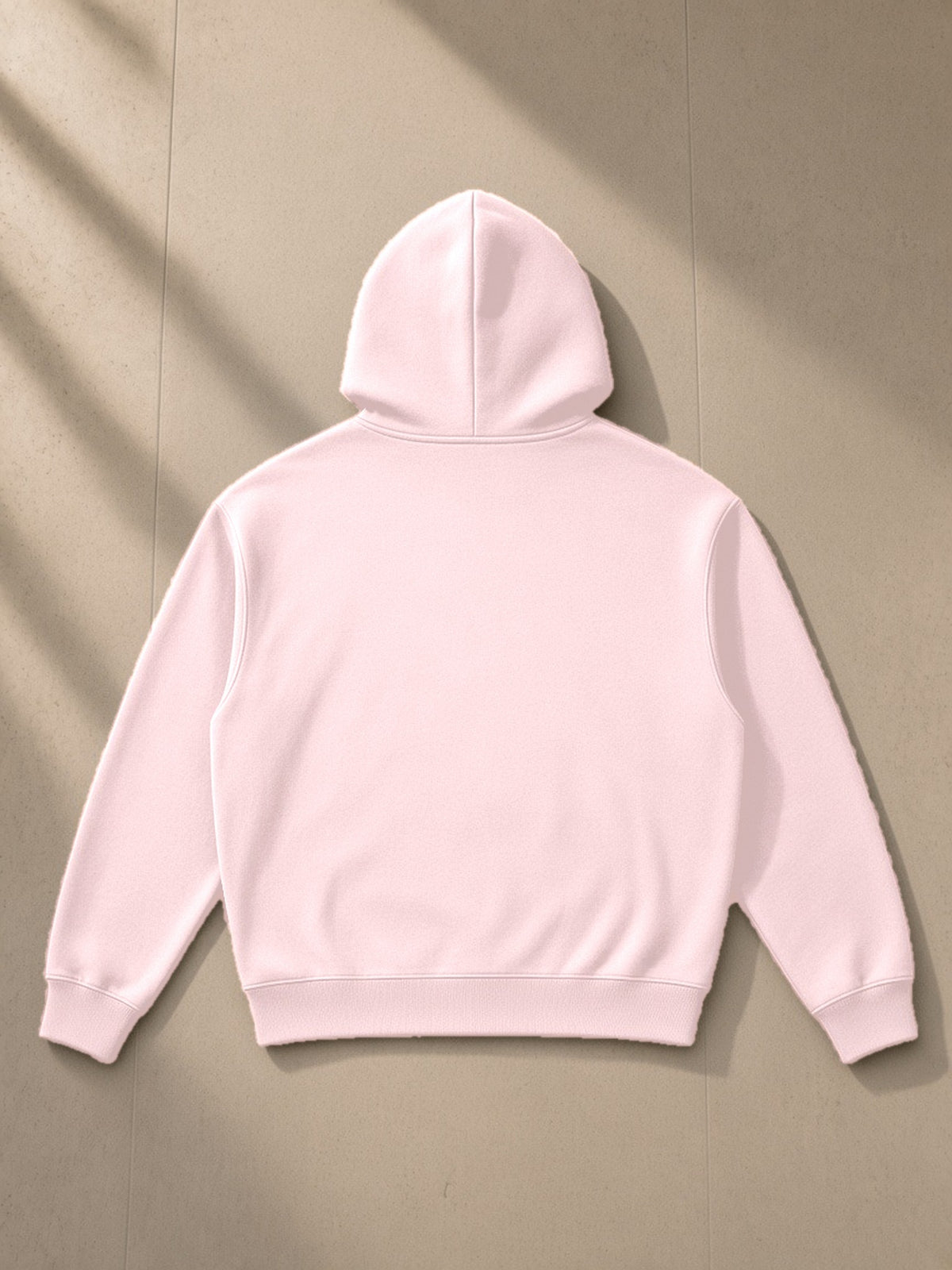 Essential Boxy Heavyweight Drop-Shoulder Hoodie in Pink, laid flat on pale limestone, back view