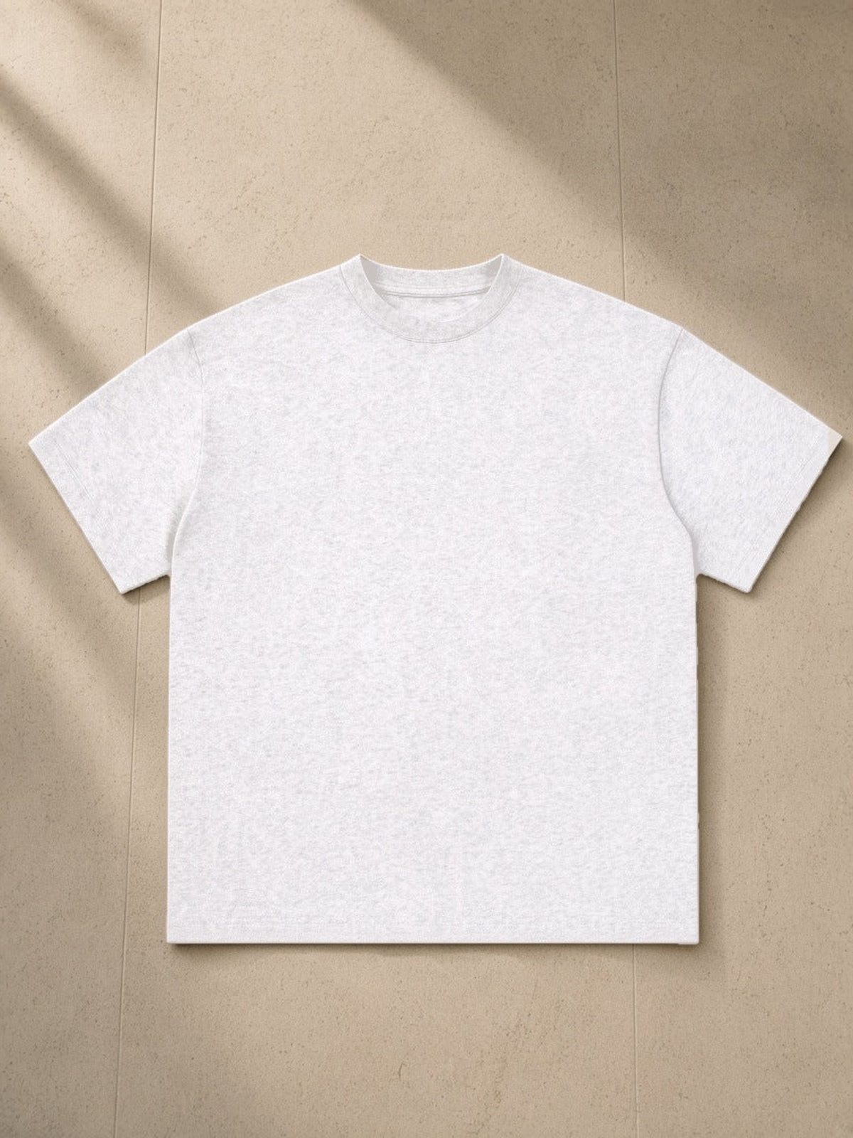 Essential Cotton T-Shirt, 260 gsm, Drop Shoulder in White, laid flat on pale limestone, front view