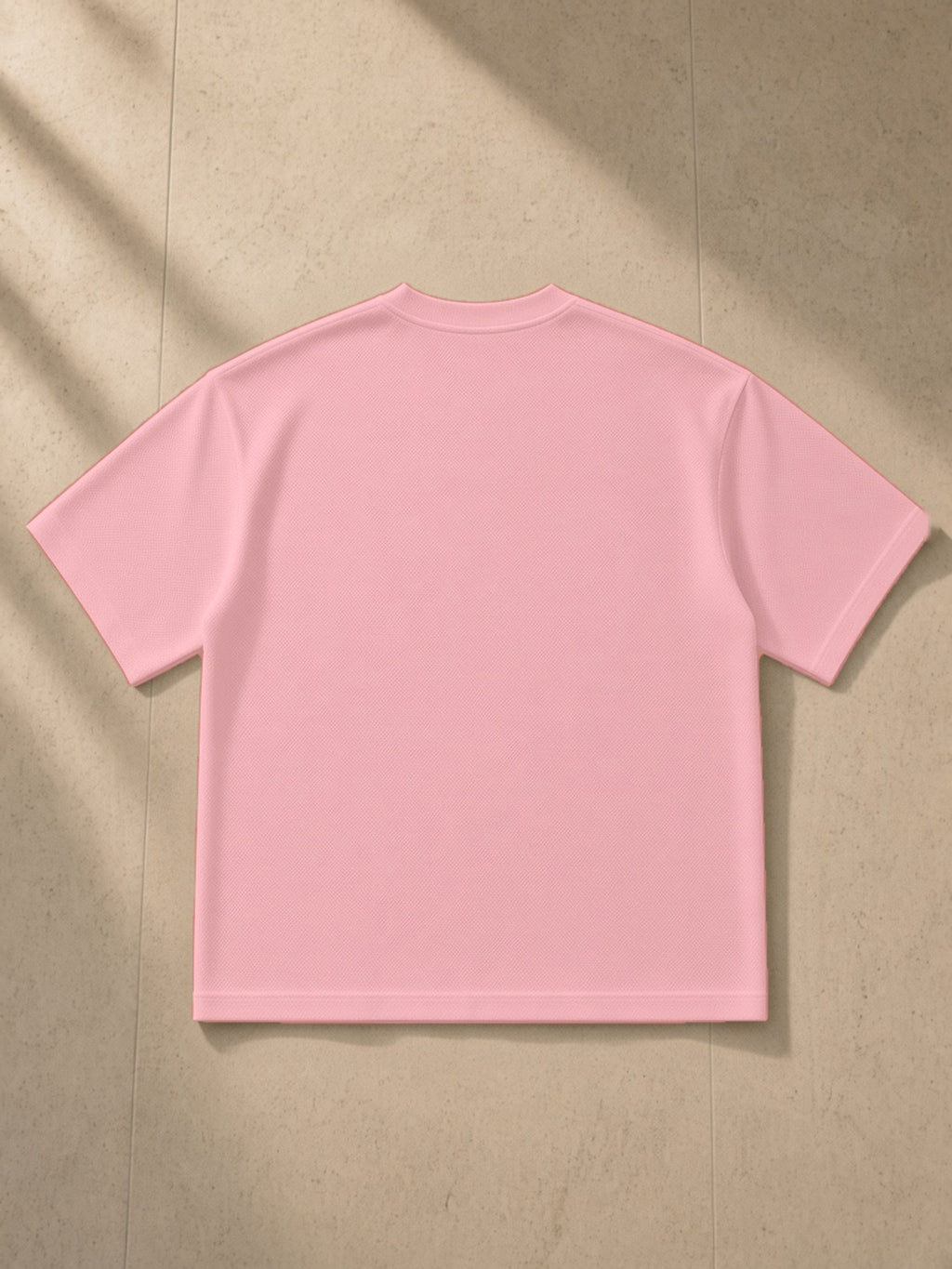 Boxy Mesh Crewneck T-Shirt in Pink, laid flat on pale limestone, back view