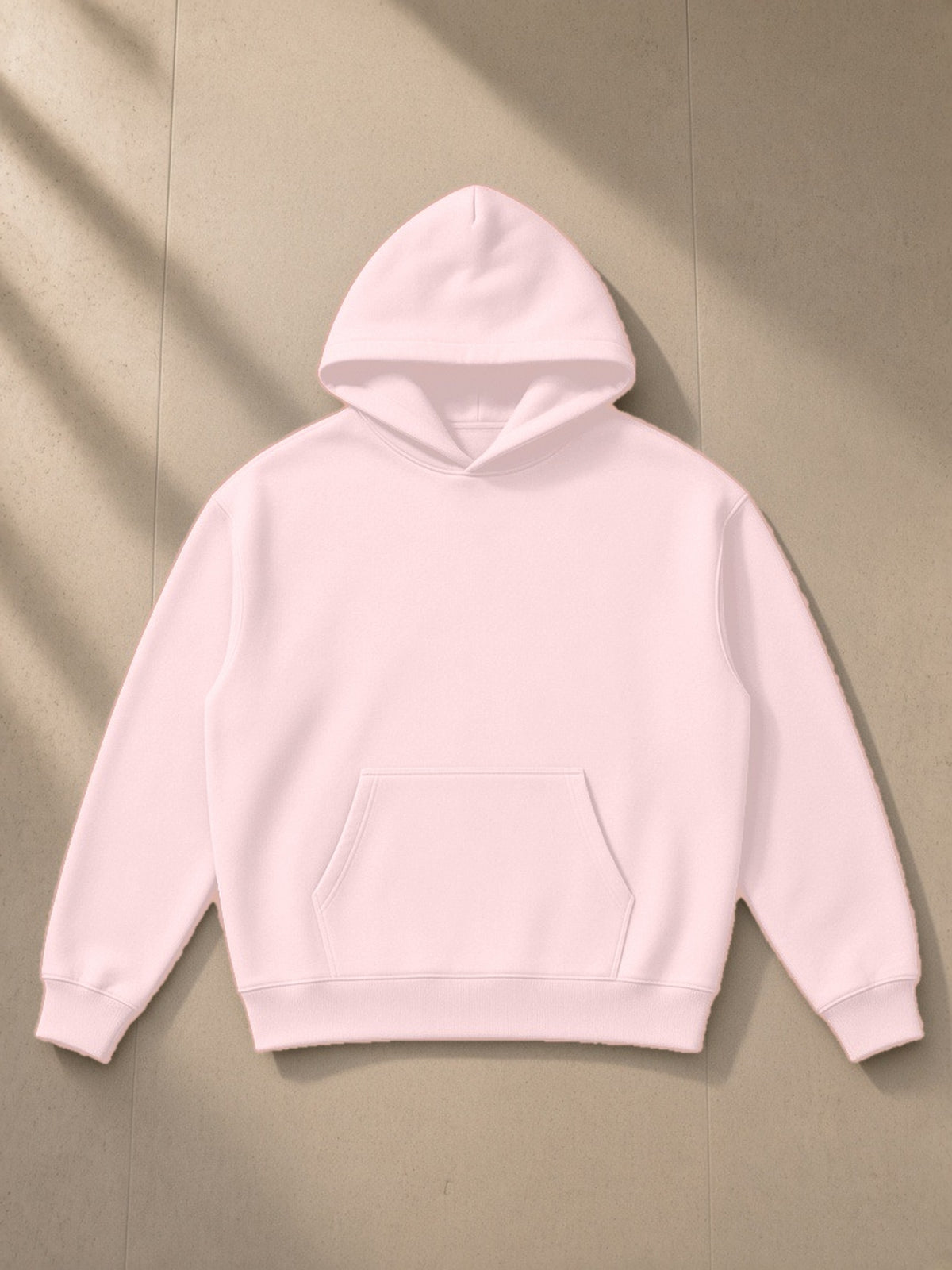 Essential Heavyweight Hoodie in Pink, laid flat on pale limestone, front view