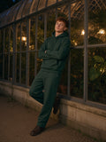 Man in Marcel Afters Essential Heavyweight Hoodie in Blackish Green, model front