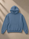 Drop Shoulder Hoodie in Haze Blue, laid flat on pale limestone, front view