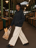 Woman in the Snow Washed Raw Edge Double Layered Hoodie in Black, model front