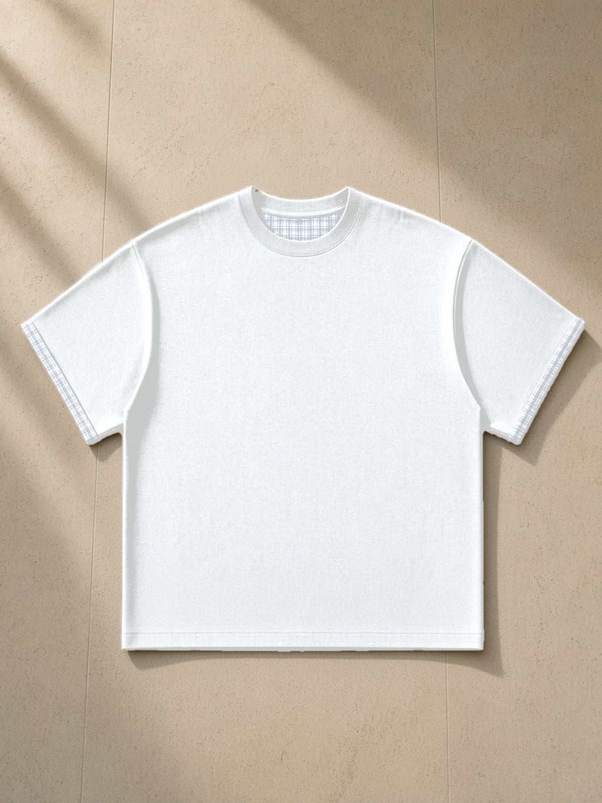 Boxy Plaid-Lined Double-Face T-Shirt in White, laid flat on pale limestone, front view
