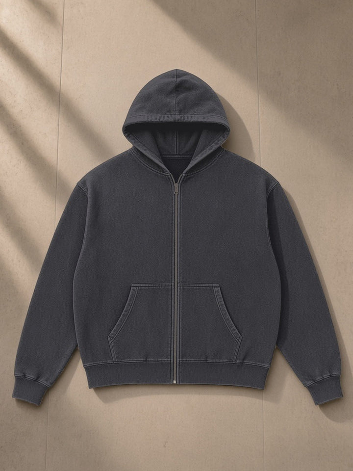 Mineral Wash Boxy Full Zip Hoodie in Dark Gray, laid flat on pale limestone, front view