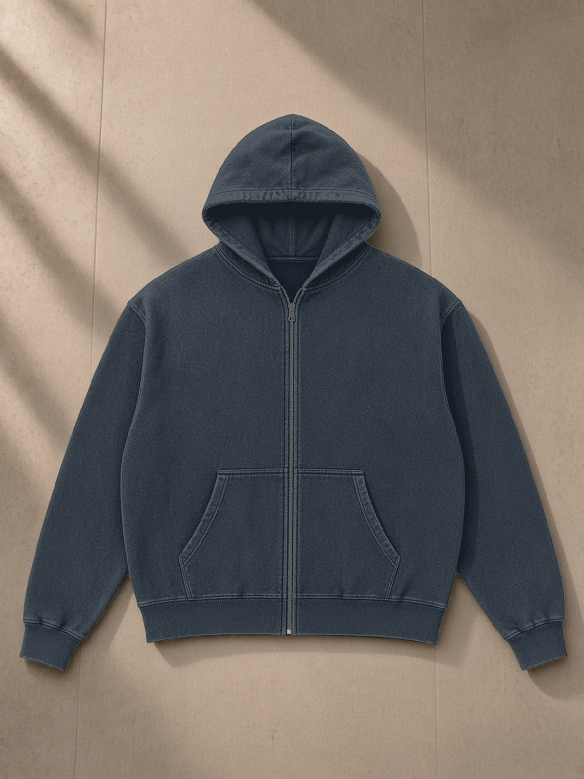 Mineral Wash Boxy Full Zip Hoodie in Navy Blue, laid flat on pale limestone, front view