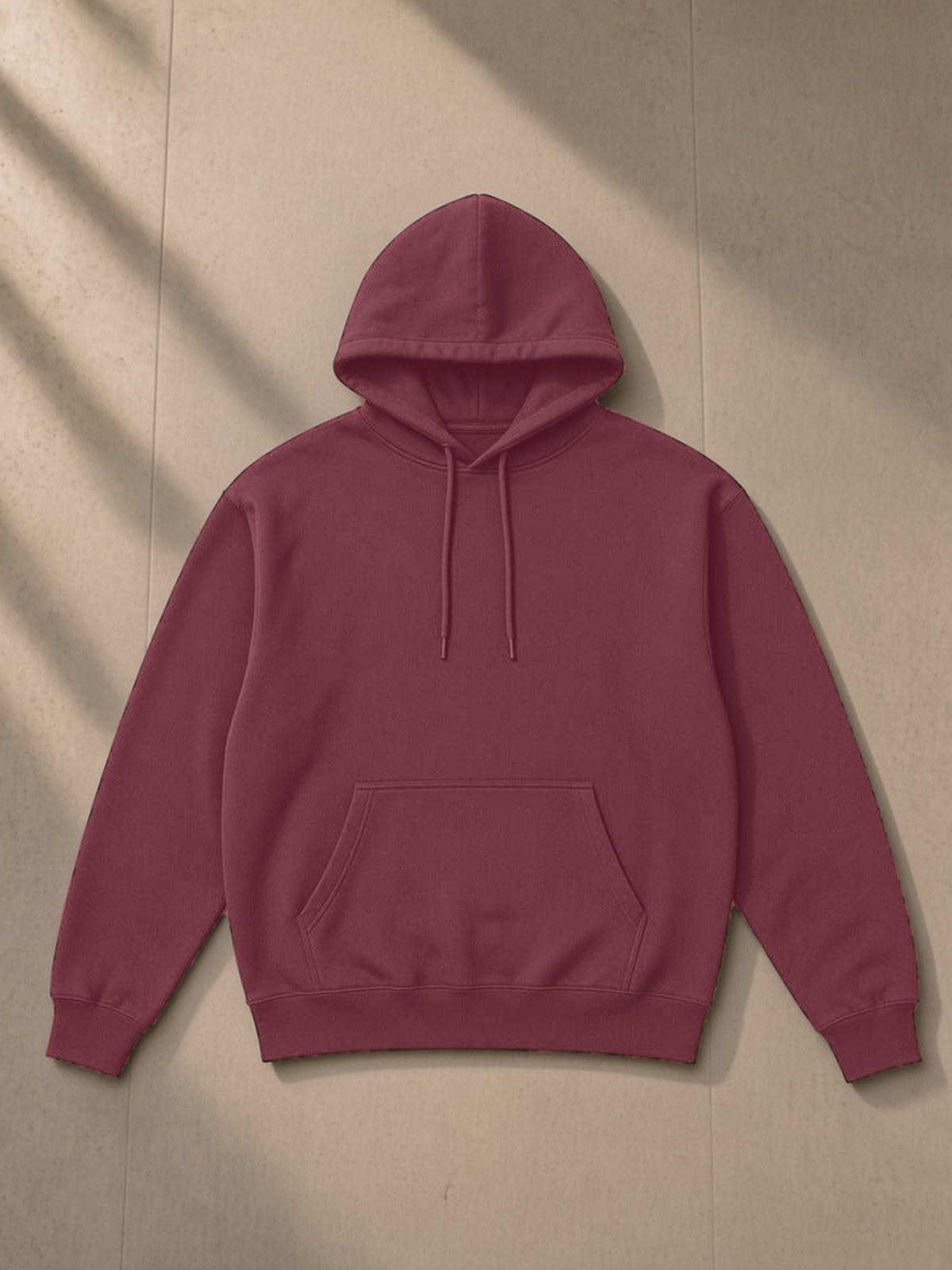 Essential Heavyweight Hoodie, 400 gsm in Dull Red, laid flat on pale limestone, front view