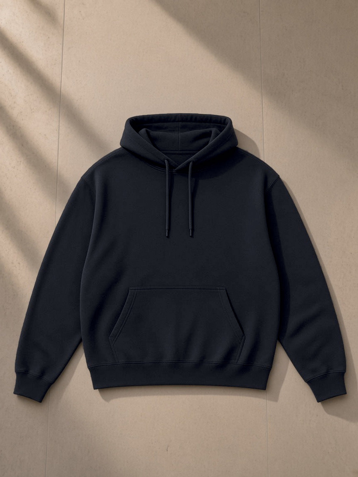 Essential Heavyweight Drop-Shoulder Hoodie in Navy Blue, laid flat on pale limestone, front view