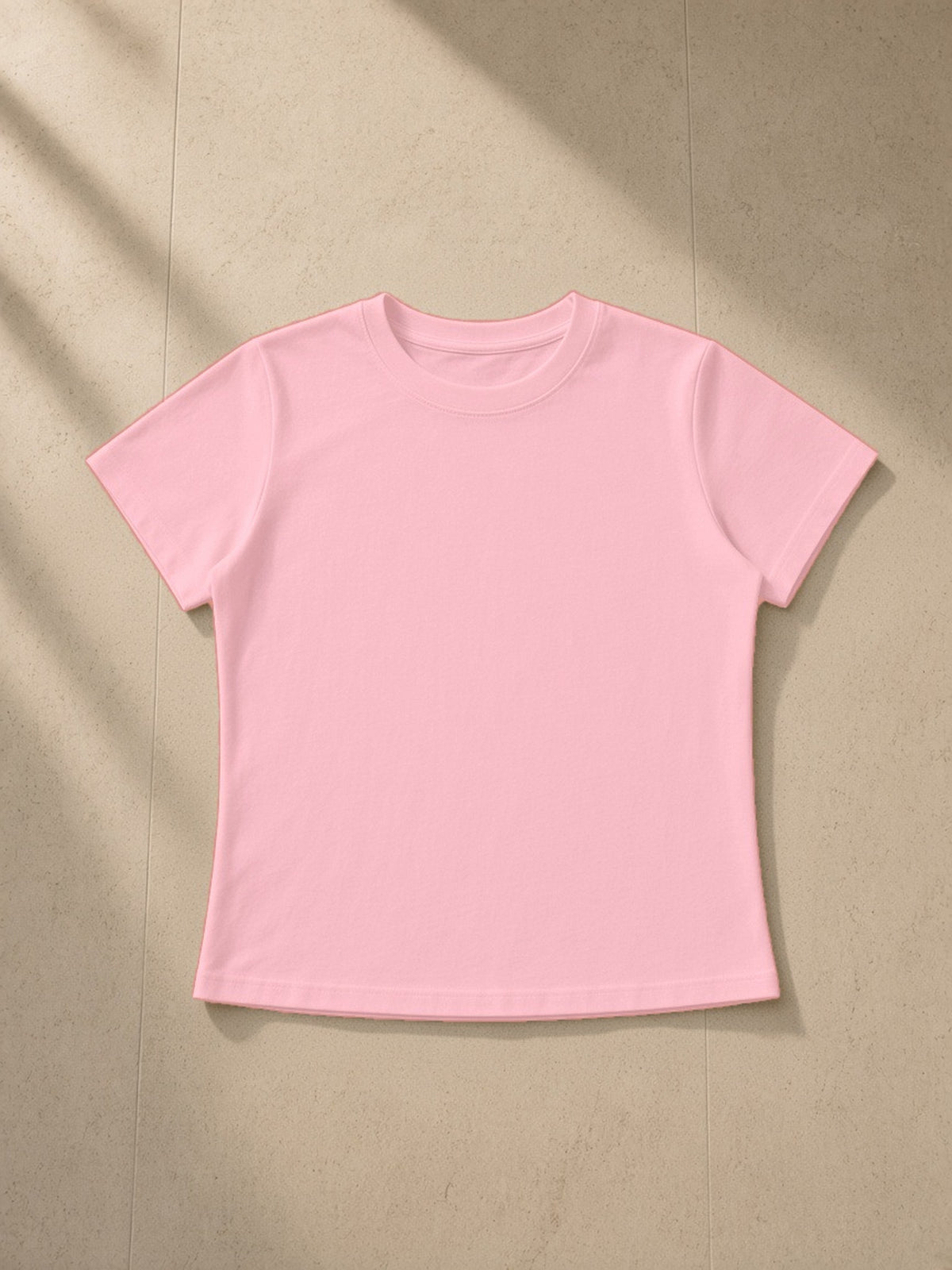 Vintage wash slim fit t-shirt in Light Pink, laid flat on pale limestone, front view
