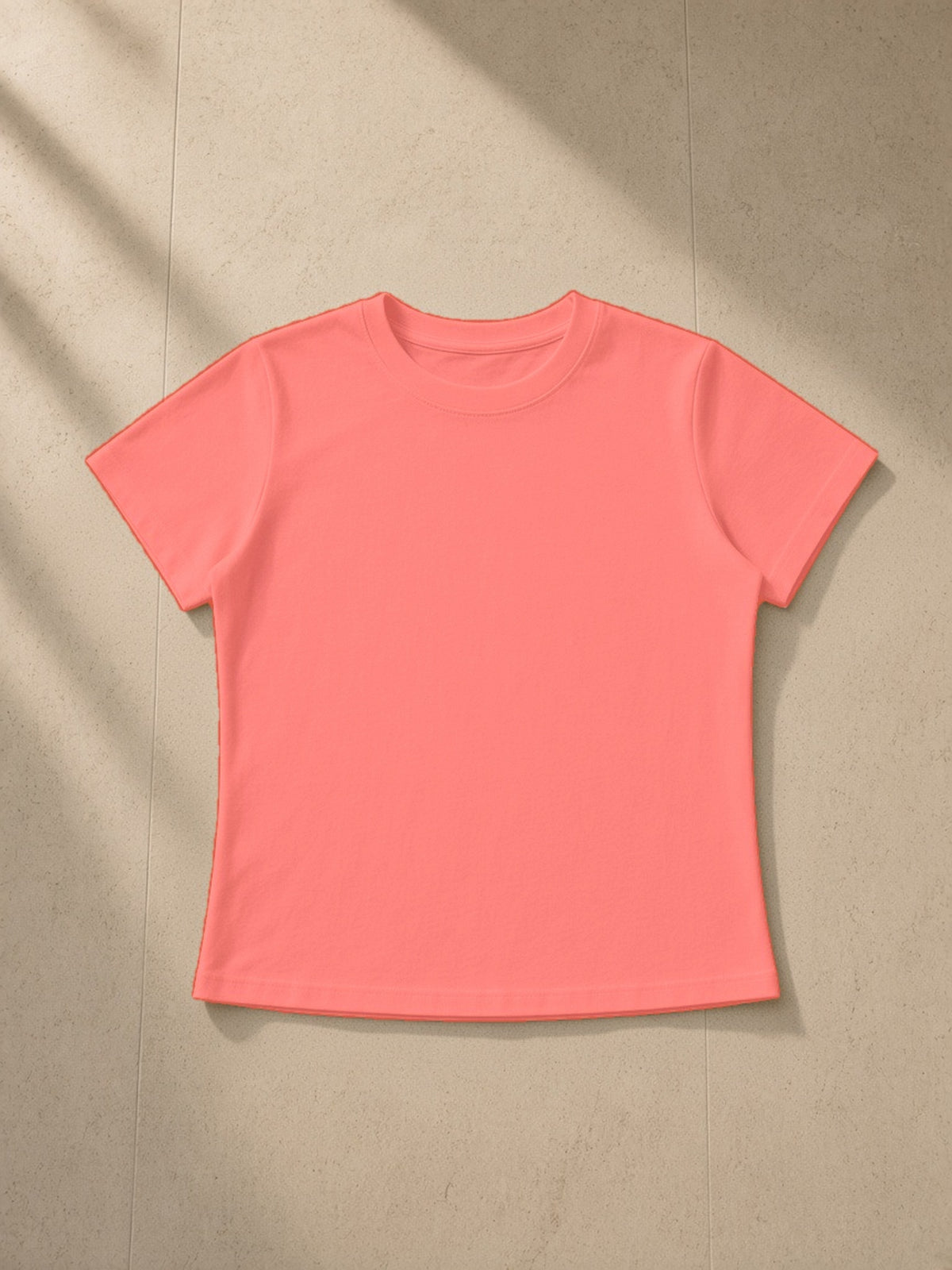 Vintage wash slim fit t-shirt in Watermelon Red, laid flat on pale limestone, front view