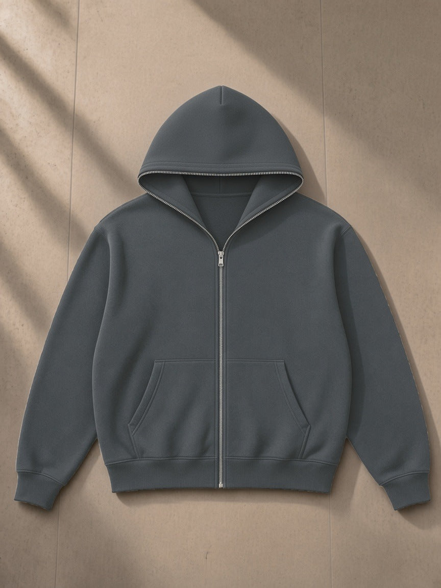 Fleeced full-zip boxy hoodie in Charcoal Gray, laid flat on pale limestone, front view