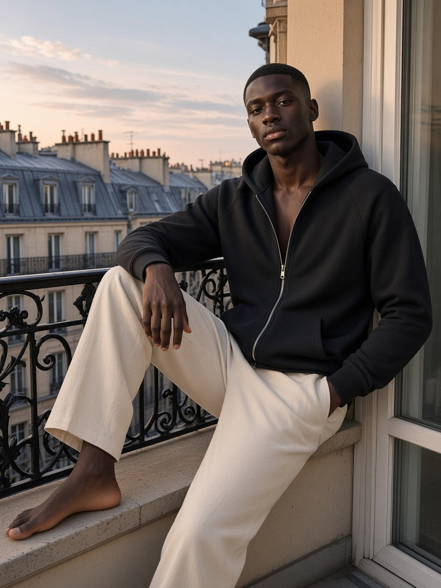 Man in Marcel Afters Essential Zip-up Fleece Hoodie — Dark in Black, worn open with no shirt, model front