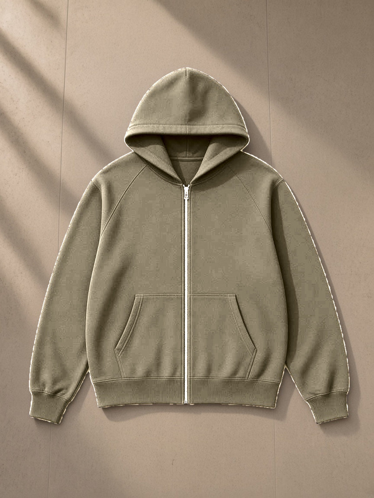 Essential zip-up fleece hoodie in Carbon Gray, laid flat on pale limestone, front view