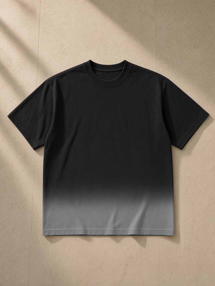 Sunfade Vintage Washed T-Shirt in Black, laid flat on pale limestone