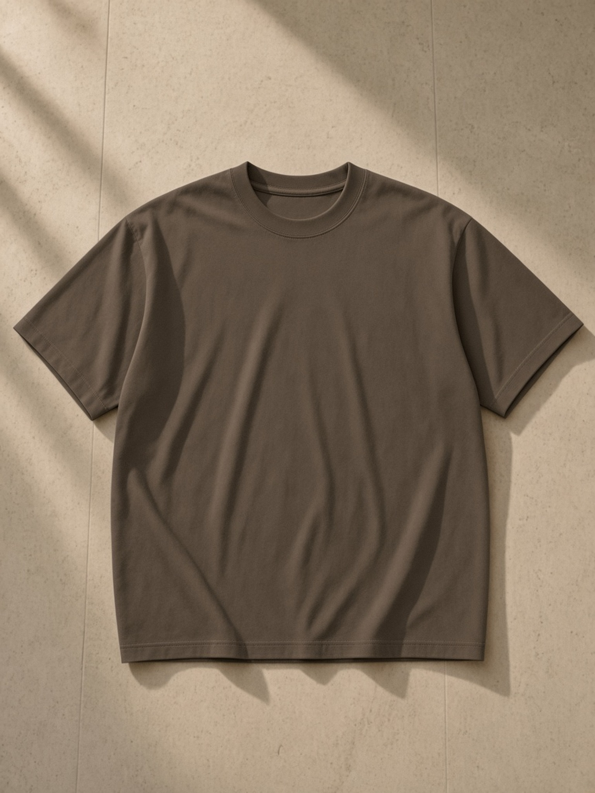 Oversized Drop Shoulder T-Shirt, 200 gsm in Brown, laid flat on pale limestone, front.