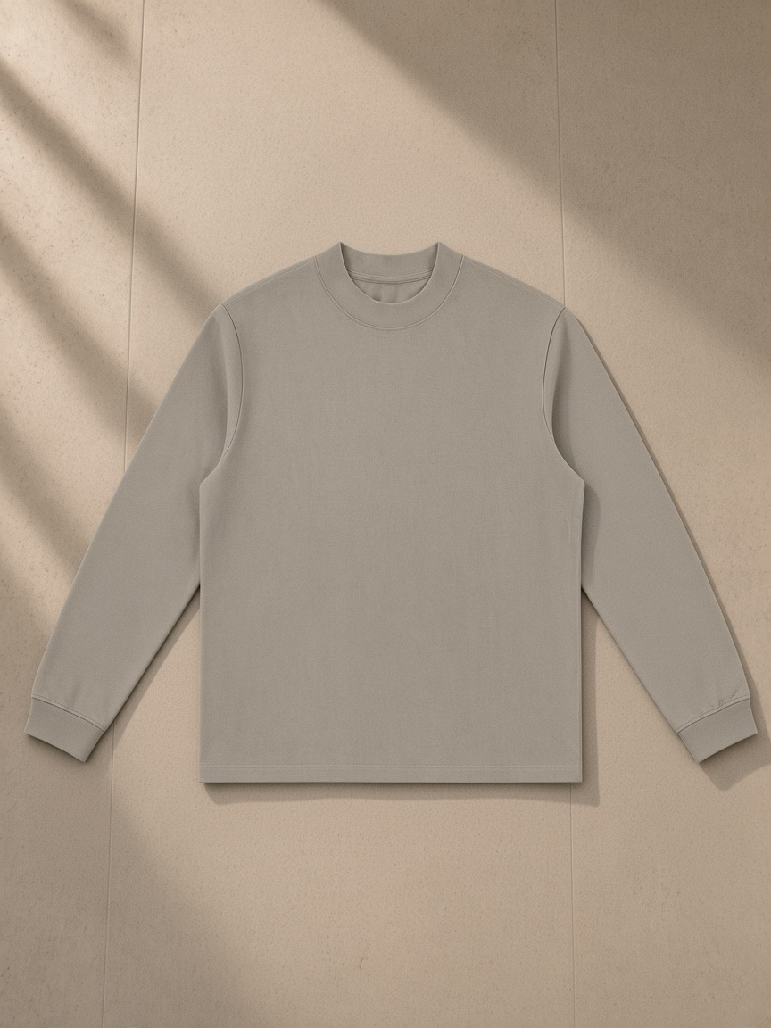 Mock Neck Sweatshirt in Dark Apricot, laid flat on pale limestone