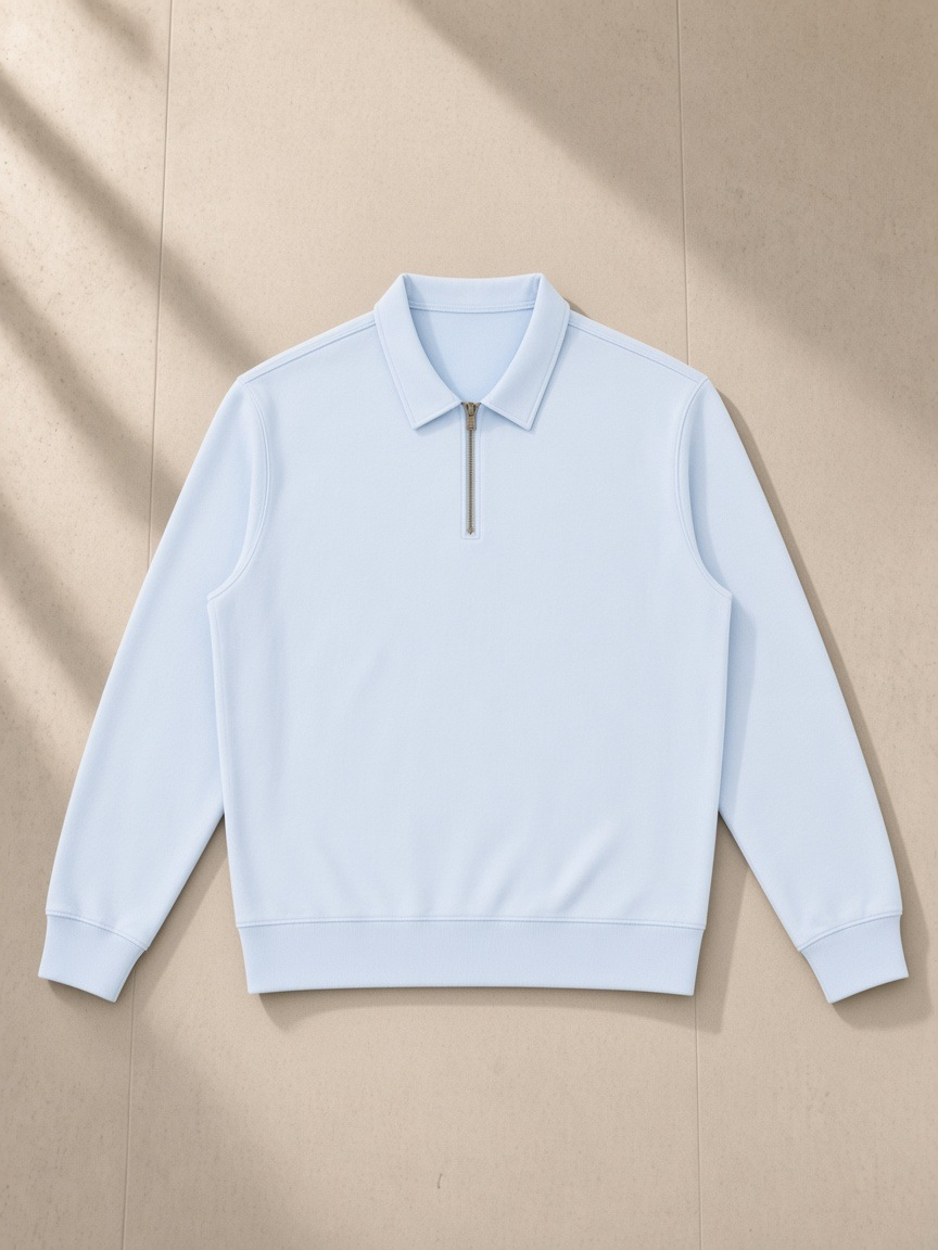 Vintage Wash Quarter-Zip Sweatshirt in Light Blue, laid flat on pale limestone, front.