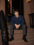 Man in the Boxy Detachable Collar Sweatshirt in Navy Blue seated on brownstone steps on Gramercy Park at night