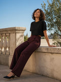 Woman in the Boxy Drop Shoulder Crop T-Shirt in Black on a sunlit limestone terrace in the morning