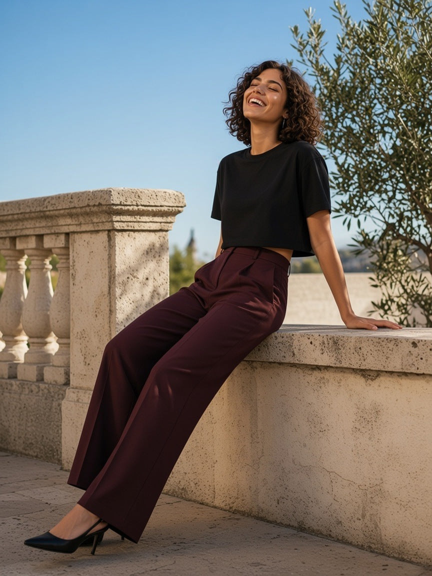 Woman in the Boxy Drop Shoulder Crop T-Shirt in Black on a sunlit limestone terrace in the morning