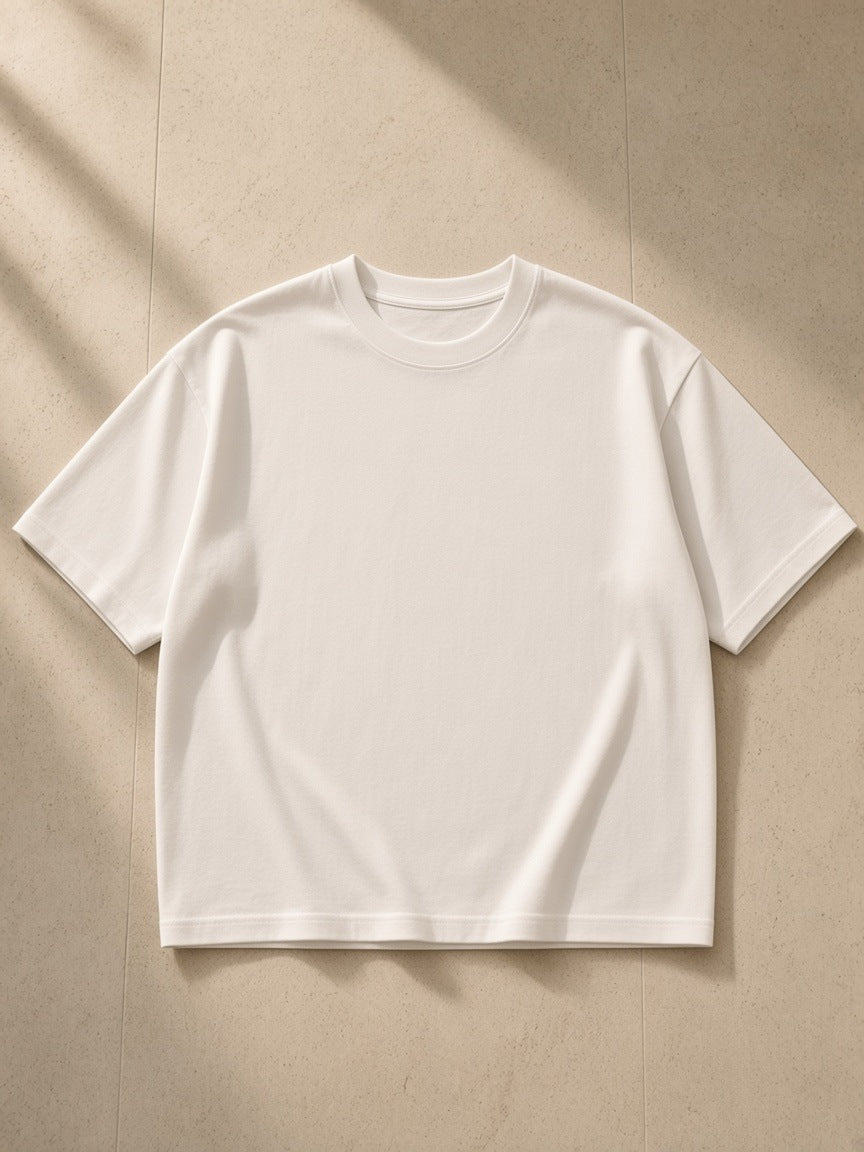 Women's Boxy Oversized T-Shirt in White, laid flat on pale limestone