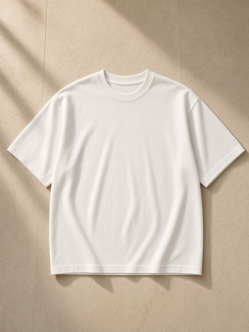 Women's Boxy Oversized T-Shirt in White, laid flat on pale limestone