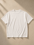 Men's Boxy Oversized T-Shirt in White, laid flat on pale limestone