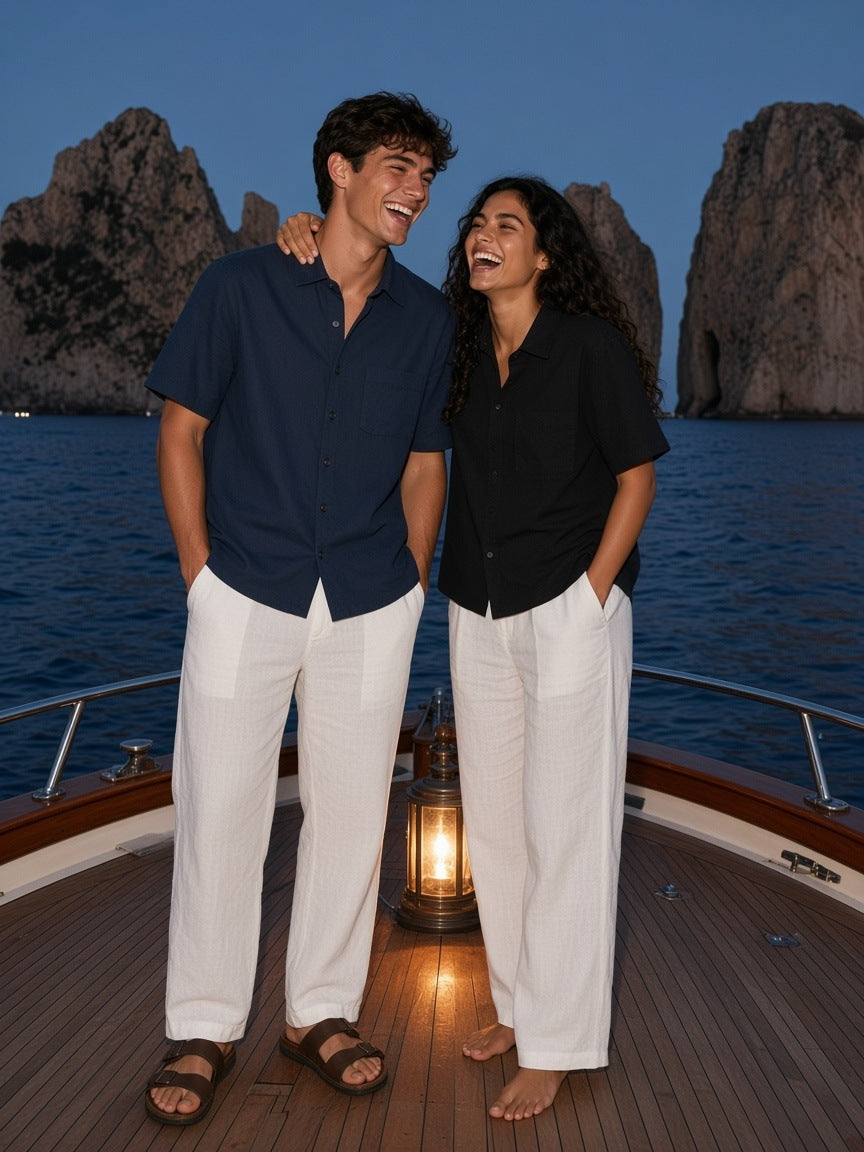 Two people in the Marcel Afters Boxy Patch Pocket Short Sleeve Shirt in Navy Blue and Black on a boat off Capri at blue hour