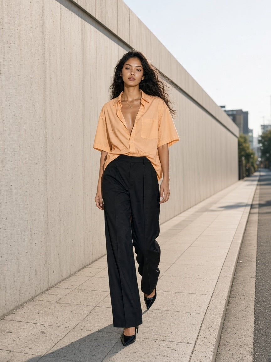 Woman in the Boxy Patch Pocket Short Sleeve Shirt in Apricot walking a concrete street in Aoyama, Tokyo by day