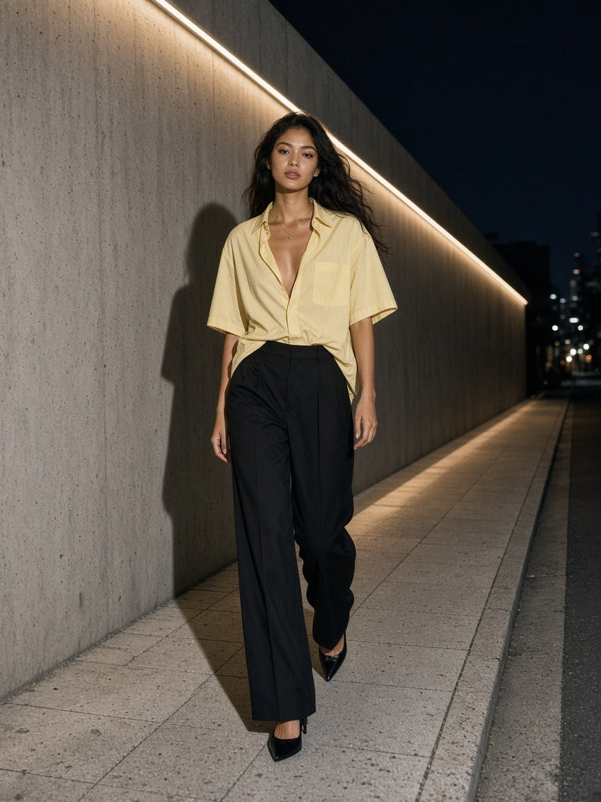 Woman in the Marcel Afters Boxy Patch Pocket Short Sleeve Shirt in Apricot walking a concrete street in Aoyama, Tokyo at night