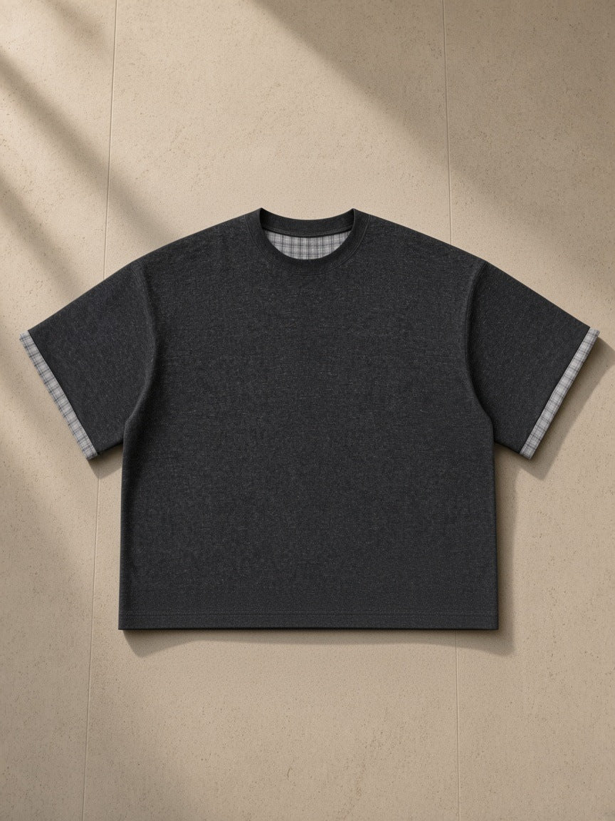 Boxy Plaid-Lined Double-Face T-Shirt in Black, laid flat on pale limestone