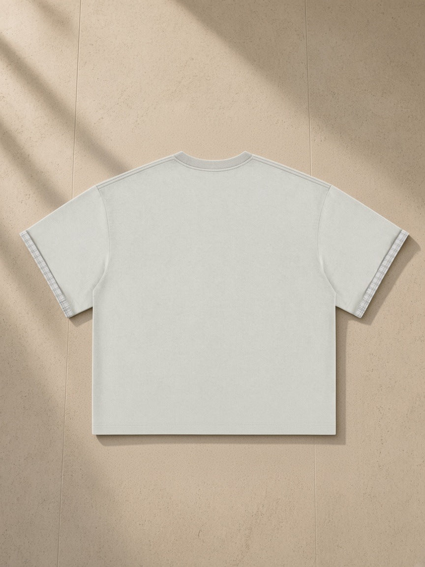 Boxy Plaid-Lined Double-Face T-Shirt in Light Gray, laid flat on pale limestone, back view