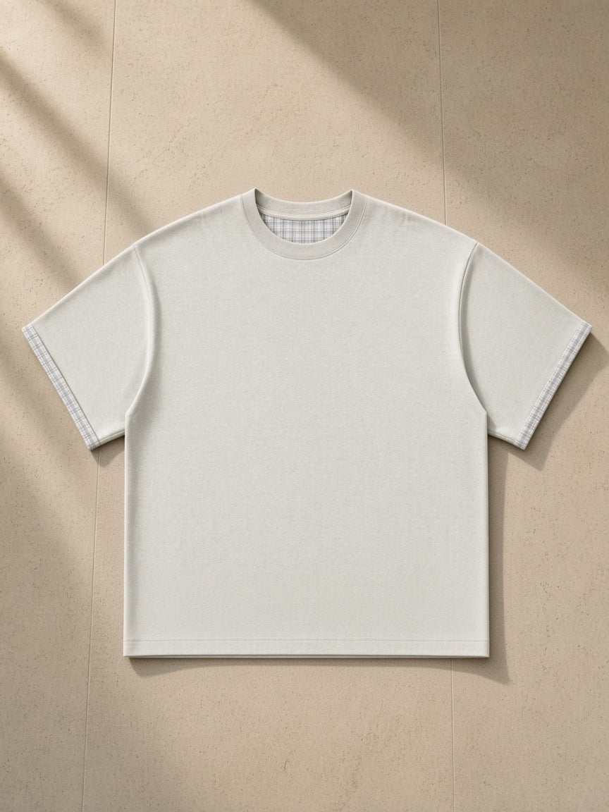 Boxy Plaid-Lined Double-Face T-Shirt in Light Gray, laid flat on pale limestone