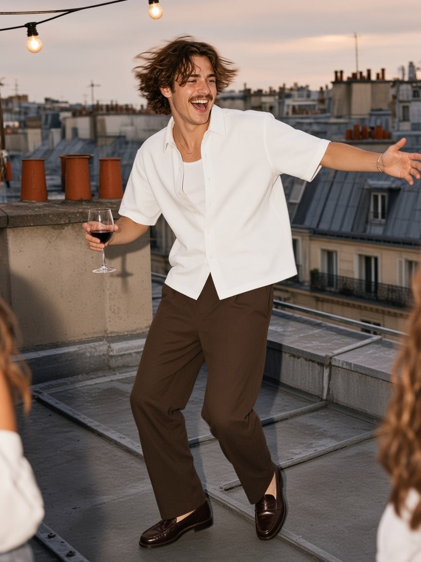 Man in the Marcel Afters Boxy Short Sleeve Shirt in White walking a Haussmann street in Paris at night