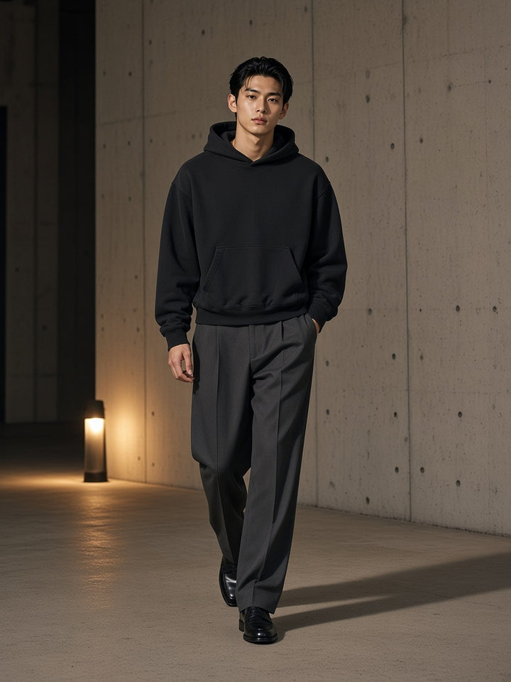 Two people à deux, the man wearing the Boxy Vintage Washed Hoodie in Black