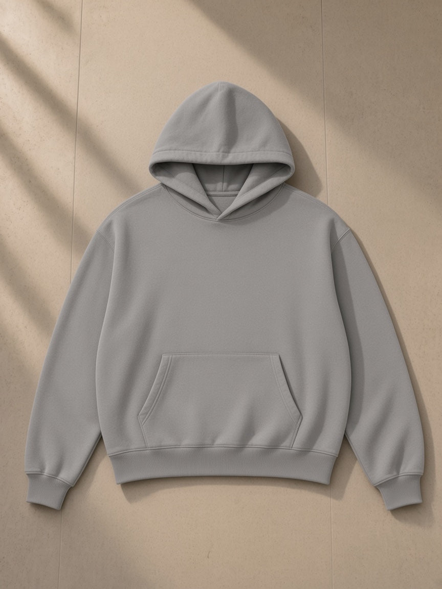 Boxy vintage washed hoodie in Light Gray, laid flat on pale limestone, front view