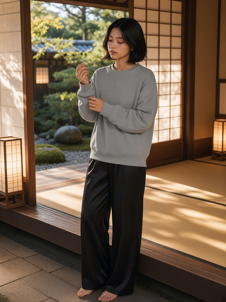 Woman in the Boxy Vintage Washed Sweatshirt in Light Gray sitting on the veranda of a Kyoto ryokan by day