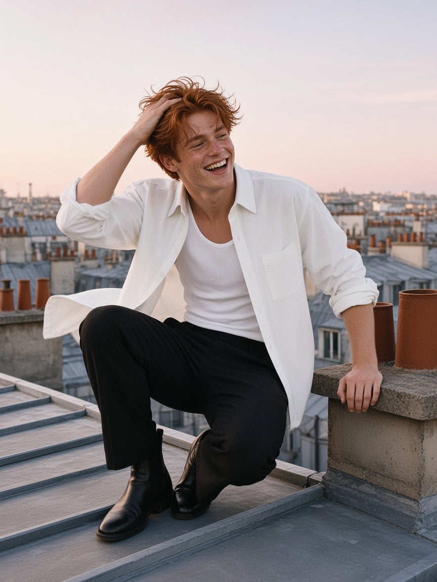 Man in the Button-Front Long Sleeve Shirt in White, worn open over a white tank, laughing on a Paris zinc rooftop at dawn