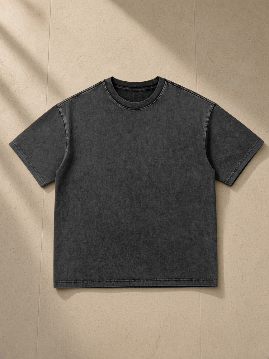 Snow Washed Heavyweight Oversize T-Shirt in Black, laid flat on pale limestone