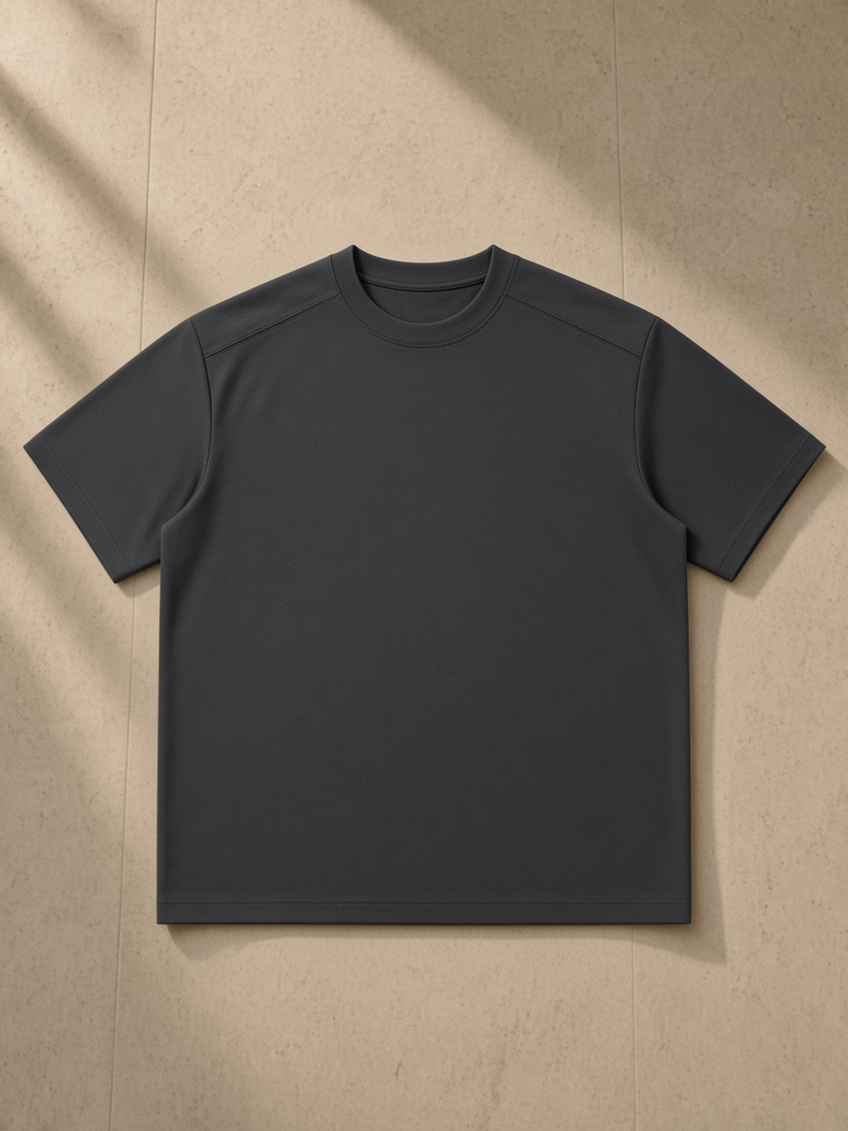 Sorona Quick-Dry Loose Fit Boxy T-Shirt in Dark Gray, laid flat on pale limestone, front.