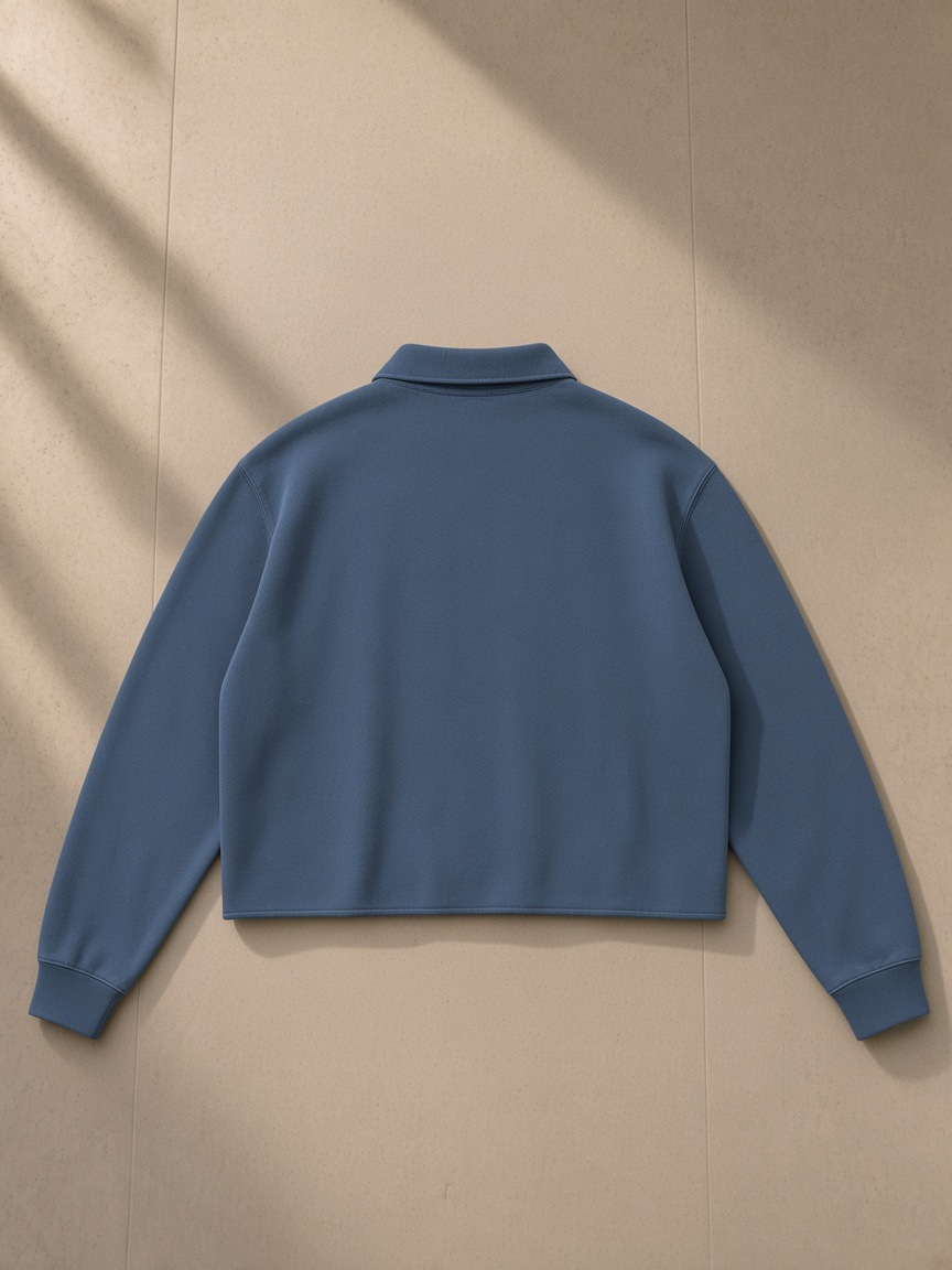 Mineral Wash Pullover Sweatshirt in Washed Blue, laid flat on pale limestone, back view