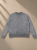 Mineral Wash Crewneck Sweater in Gray, laid flat on pale limestone