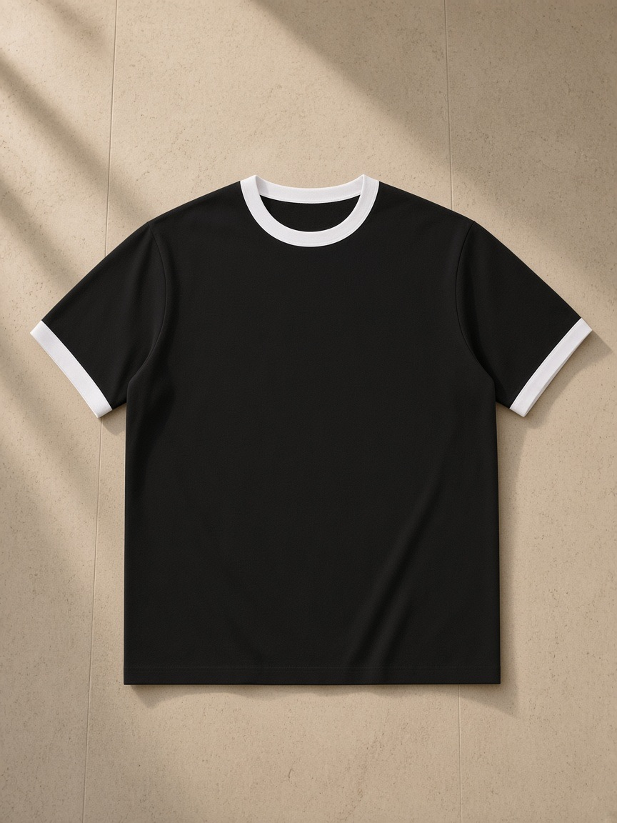 Unisex ringer t-shirt in Black, laid flat on pale limestone