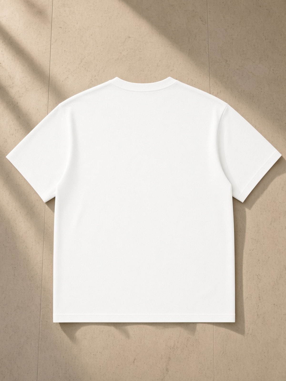 Regular Fit Coolmax T-Shirt in White, laid flat on pale limestone, back.