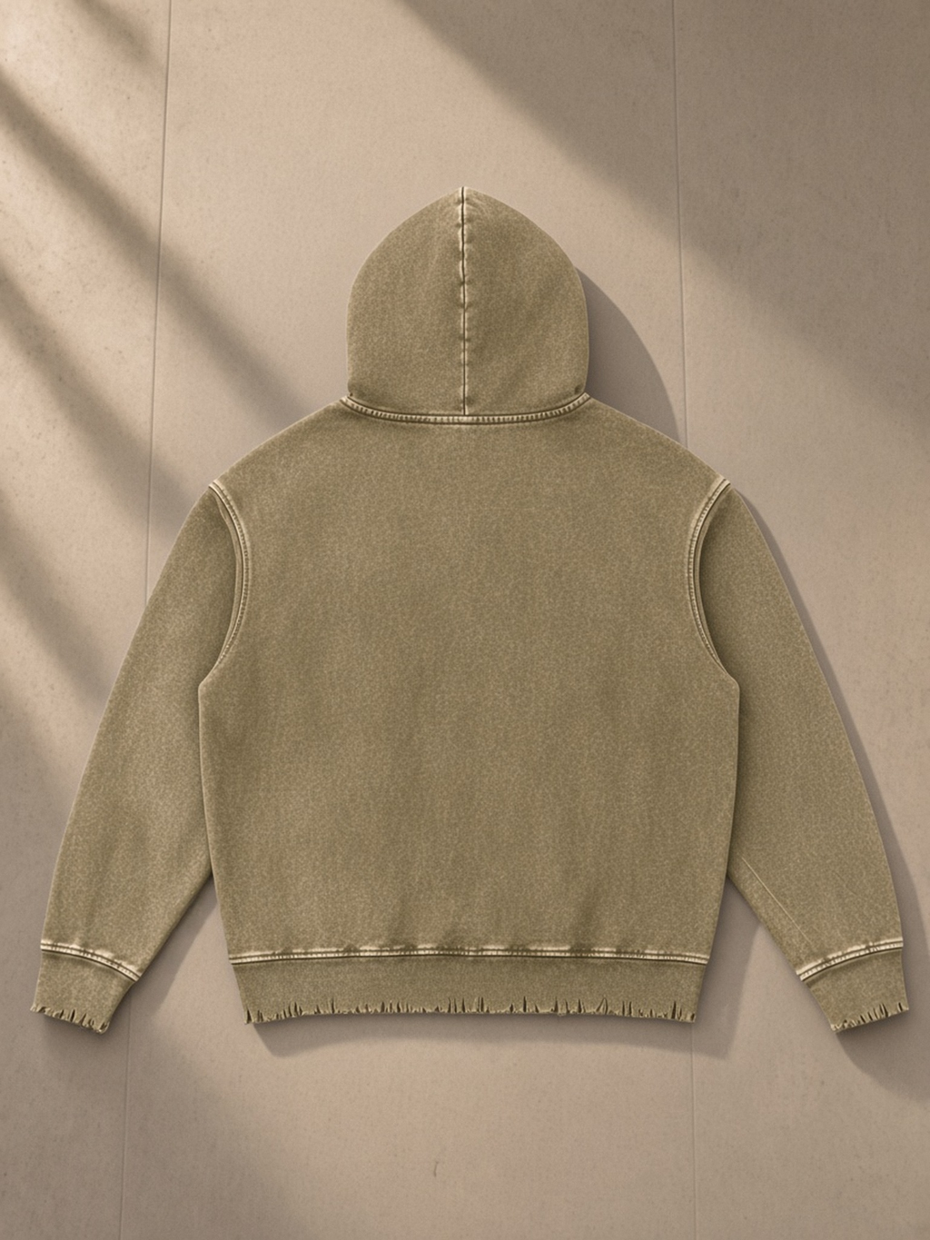 Snow Wash Hand-Frayed Heavyweight Hoodie in Brown, laid flat on pale limestone, back.