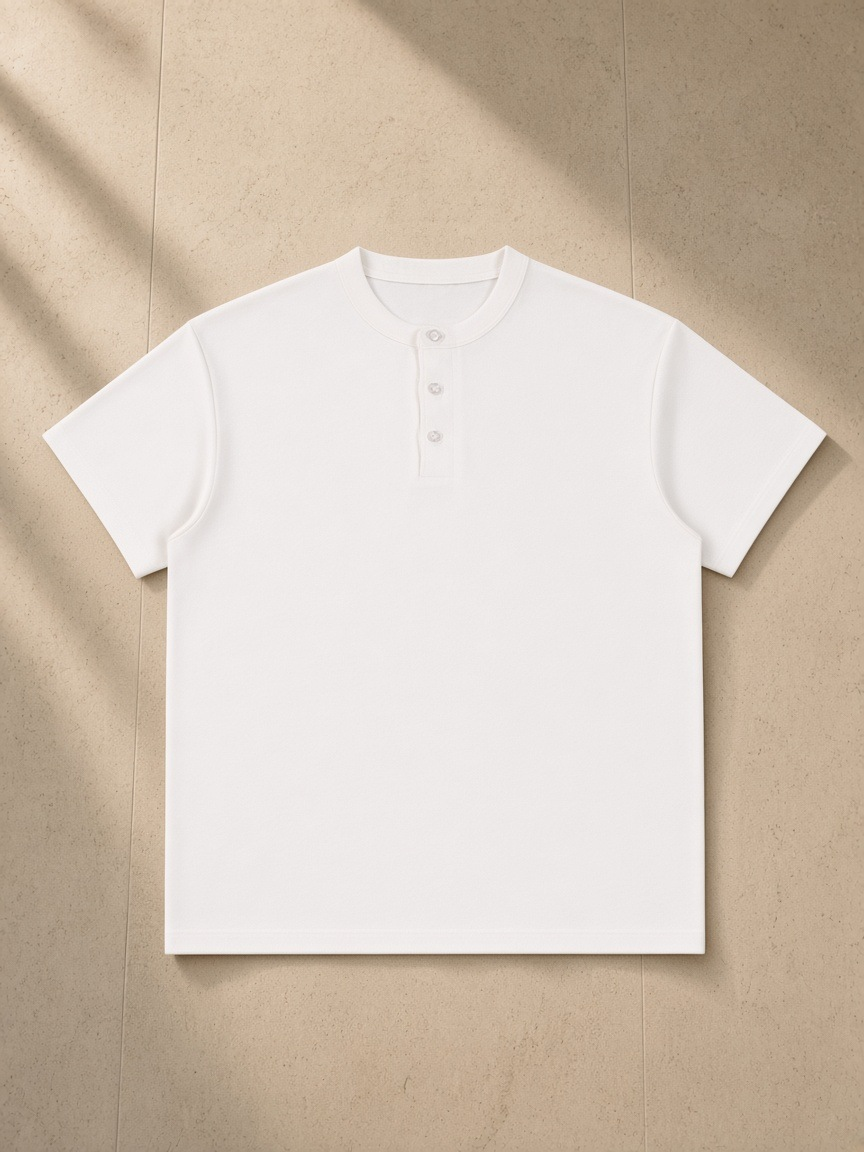 Short Sleeve Henley Shirt in White, laid flat on pale limestone